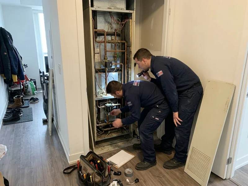 Open McQuay vertical fan coil cabinet in a Toronto condo closet